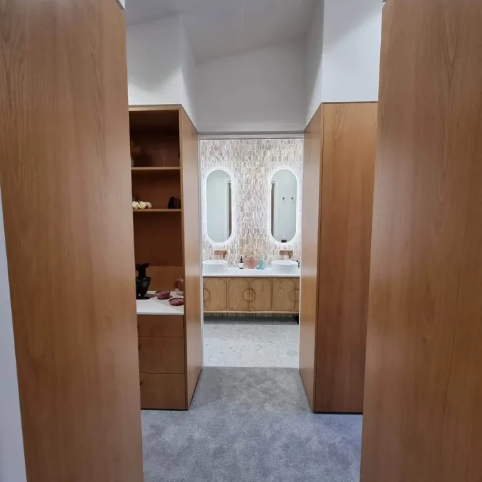 Modern luxury bathroom with backlit oval mirrors and custom vanity lighting in Melbourne