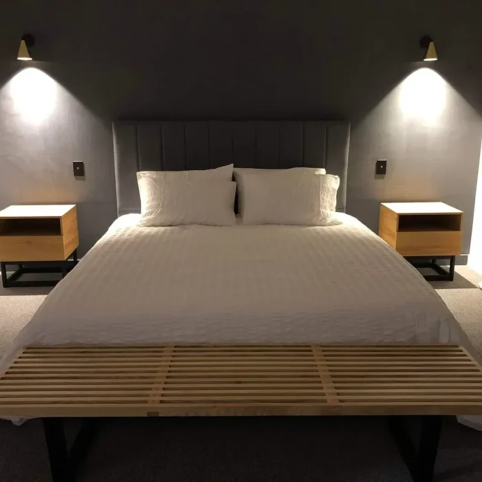 Modern bedroom interior styled with wall-mounted bedside reading lights and ambient sconces