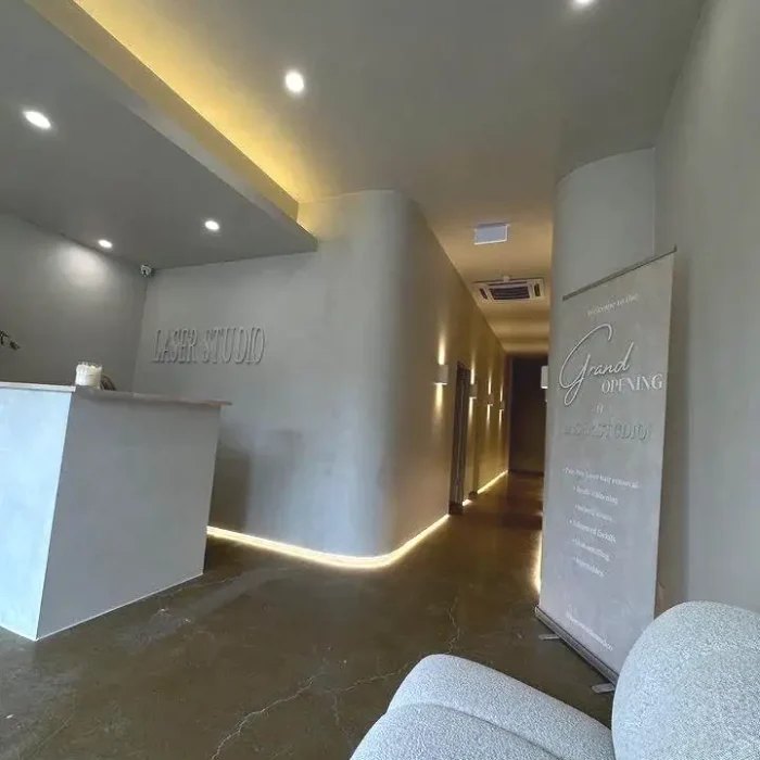 Modern commercial reception desk and lit corridor inside a laser and skin clinic in Melbourne
