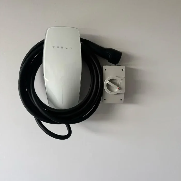 Electrician installing a wall-mounted EV charger in a Melbourne home