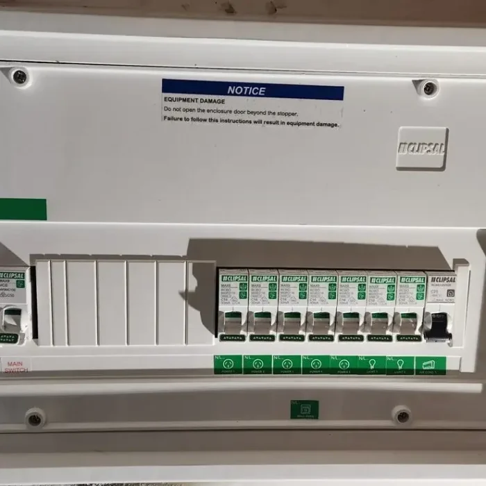 Upgraded domestic switchboard panel with safety notices and RCBO circuit breakers